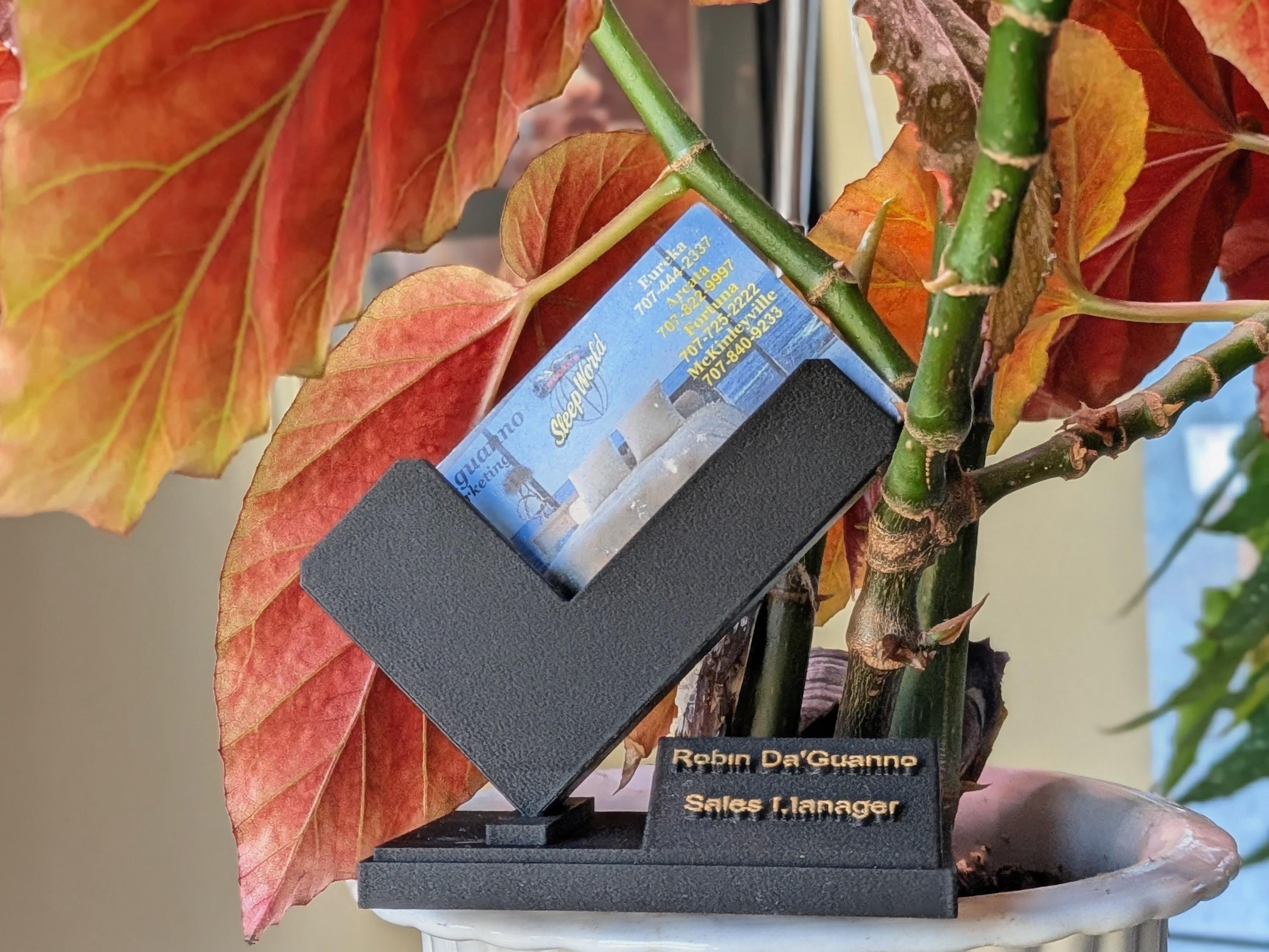 Bespoke 3D printed card display featuring custom embossed text for professional branding and office decor.