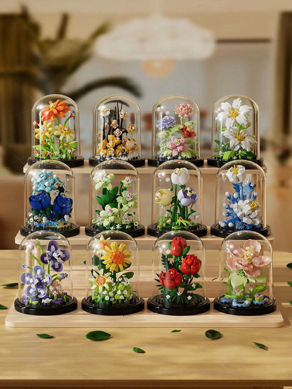 Collection of decorative floral arrangements in glass domes on a wooden stand