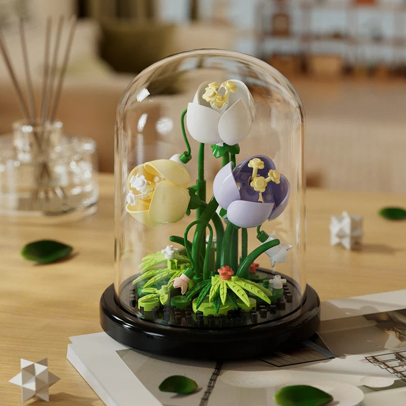 White and purple eternal flowers building block model in a glass dome on a wooden table