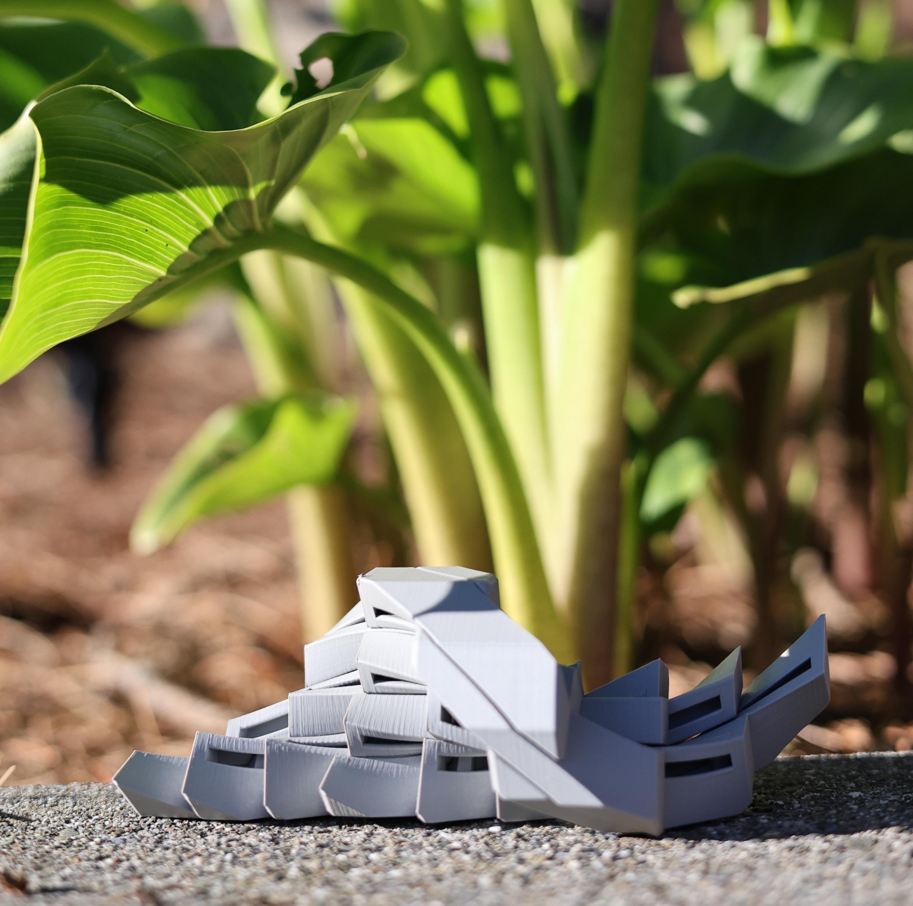 Ergonomic EDC kinetic worry stone being used for stress relief and quiet fidgeting during professional meetings.