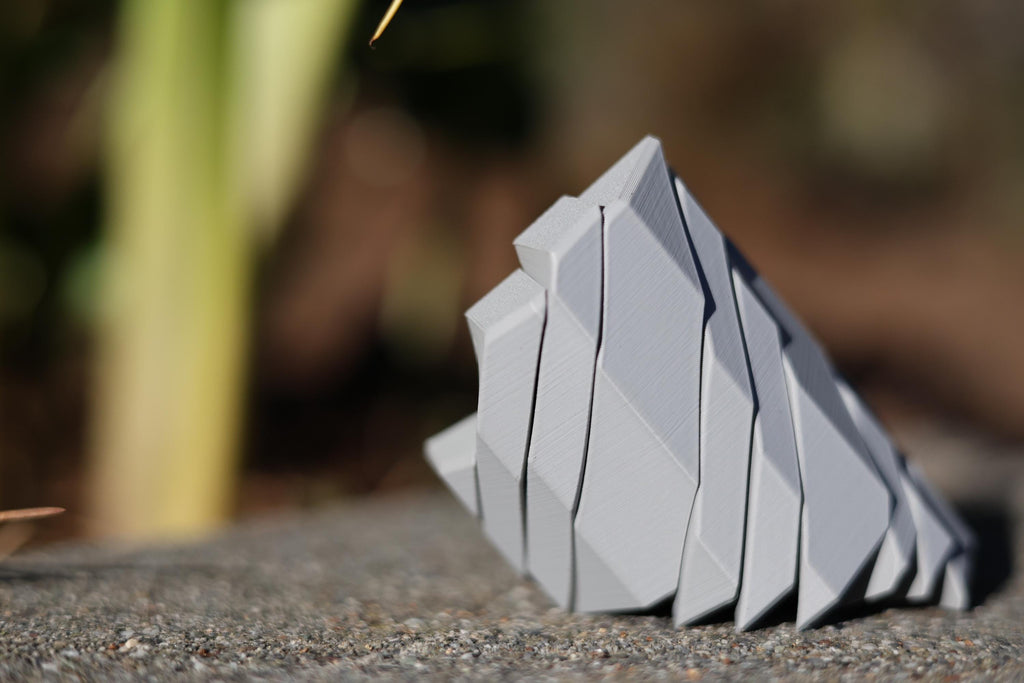 Collection of minimalist geometric desk toys in various colors, ideal for executive gifting and modern workspace decor.