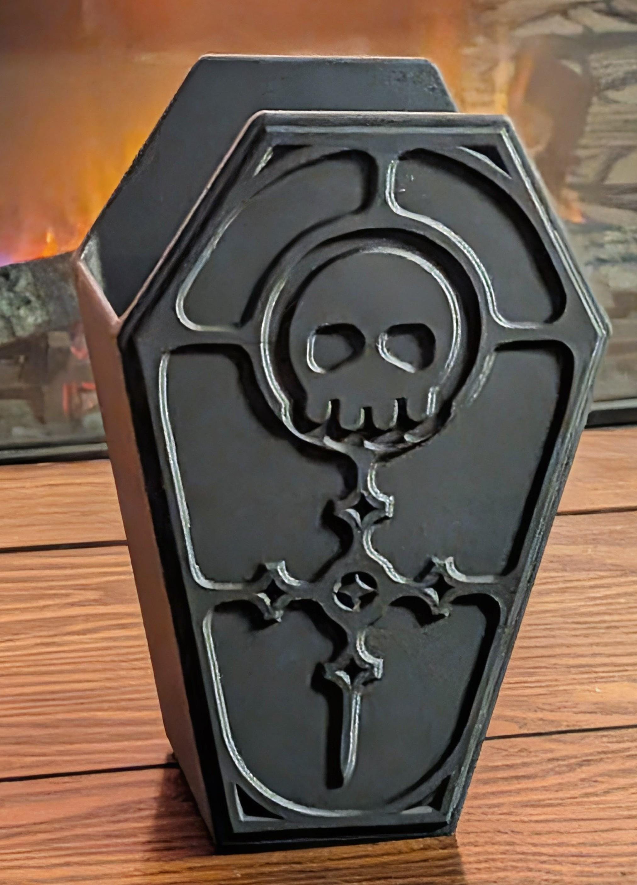 Gothic makeup brush holder coffin design for alternative vanity decor and macabre home organization.