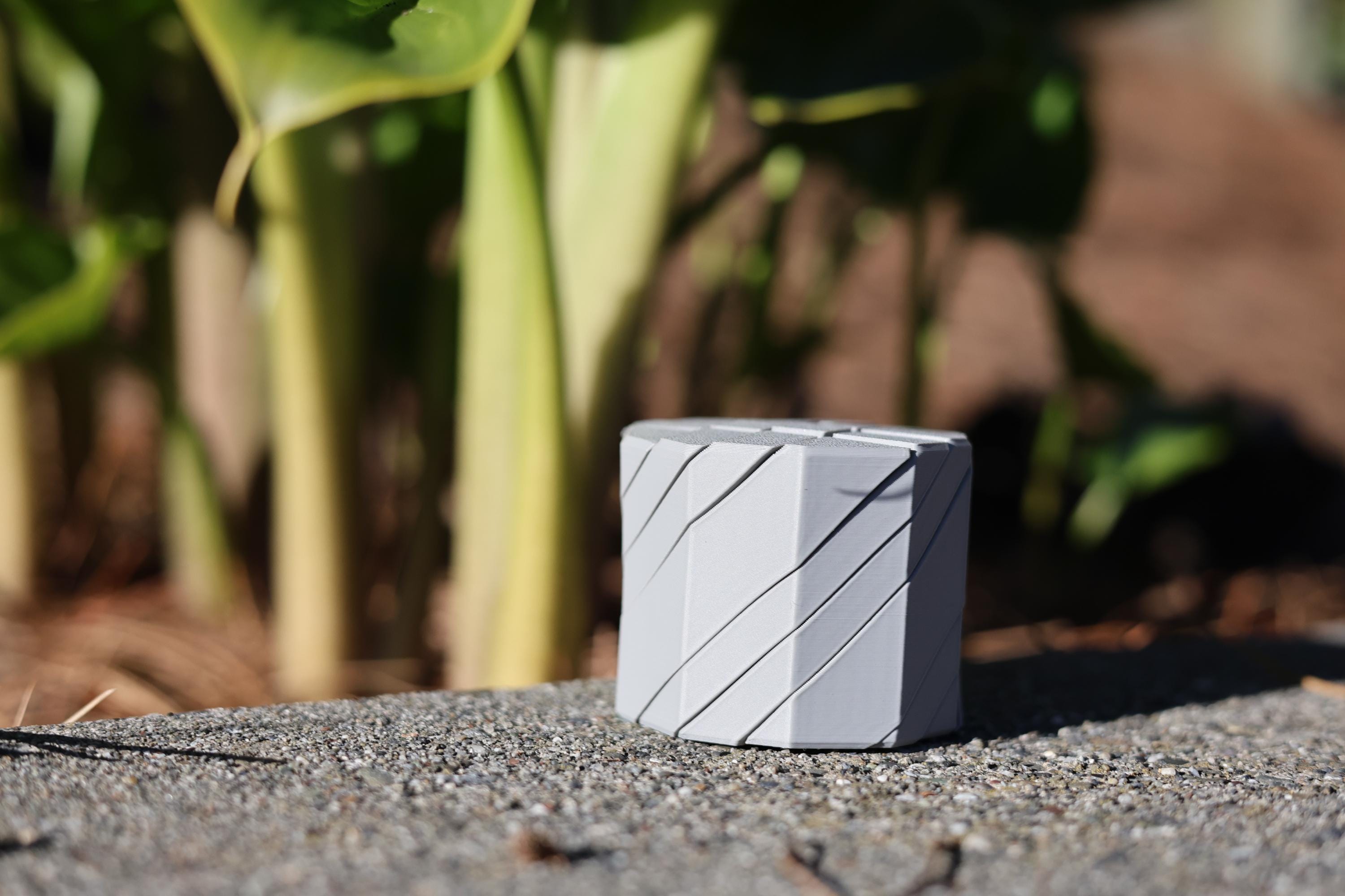 Close-up of the linear ribbed texture on a matte finish kinetic fidget stone for bilateral stimulation and ADHD focus.